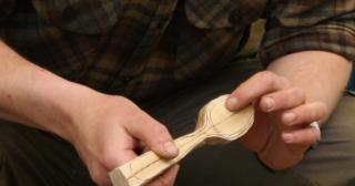 Hand carving a spoon
